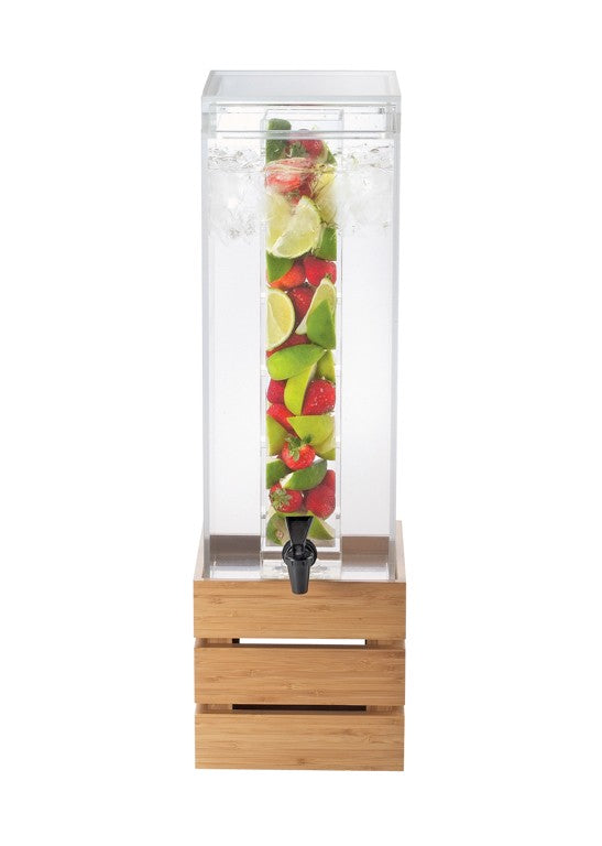 A tall, clear beverage dispenser filled with water and ice features a BPA free infusion chamber packed with cut strawberries, lime, and green apple slices. The black spigot and wooden crate-style base complete its refreshing display.