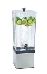 A clear 3-gallon beverage dispenser with a black spigot and stainless steel base, filled with water. Sliced cucumbers, lemon rounds, and mint leaves float at the top, while a central ice core keeps the drink cold. Background is plain white.