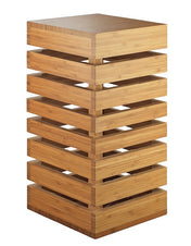 A modern, rectangular wooden Display Crate Tower made of stacked horizontal slats with open gaps between each layer. The natural wood finish gives a warm tone, and the staggered design is perfect for shelving or showcasing items.