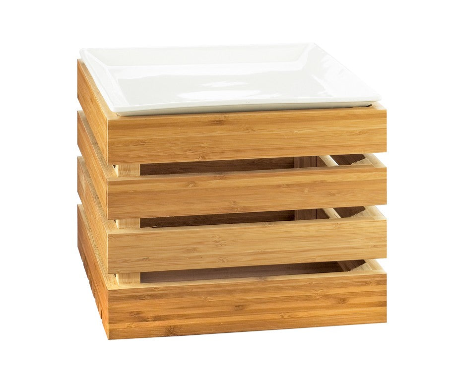 A square, light wood crate riser with horizontal slats, stacked open sides, and a glossy white rectangular plate resting on top. The crate appears sturdy and modern, photographed against a plain white background.