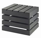A black wooden side table with a modern, minimalist design. Inspired by a Midnight Bamboo Crate Riser, it features four thick horizontal slats and stacked gaps for an open look. The flat surface and base create a sleek, square shape.