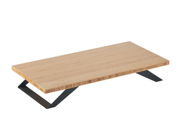 A modern rectangular coffee table with a light bamboo top and two black metal legs angled outward, forming a low, sturdy base. The minimalist, geometric design contrasts the natural bamboo surface with a sleek black metal frame.