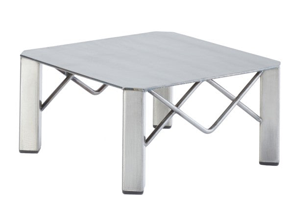 A small, square metal table with a polished finish, flat gray surface, four thick legs, and diagonal support bars connecting the legs beneath the tabletop in an X-shaped pattern. The table boasts a minimalist, industrial design inspired by Industrial Risers.
