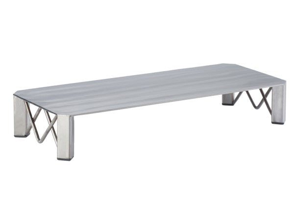 A low, rectangular metal platform with a flat surface and four angled legs. Each leg features an X-shaped support structure, giving this Industrial Riser a modern look. The metal rectangular riser has a brushed, matte finish.