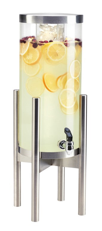 A tall, cylindrical 3 gallon beverage dispenser with a stainless steel stand, filled with lemonade, lemon slices, cranberries, and ice. The clear container has a spigot near the base for dispensing drinks and is topped with a metal lid.