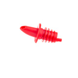 A bright red TableCraft Products Free Flow Pourer with a tapered spout and ribbed neck lies on its side against a white background. The spout is slightly angled, and the ribbed section fits securely inside a bottle opening.