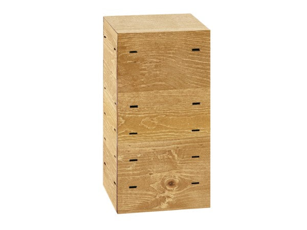 A tall, rectangular wooden box with three stacked sections, each resembling a drawer or compartment. Crafted from rustic pine, the wood grain is visible with small rectangular cutouts on the front and sides, typical of a Madera Crate Riser.