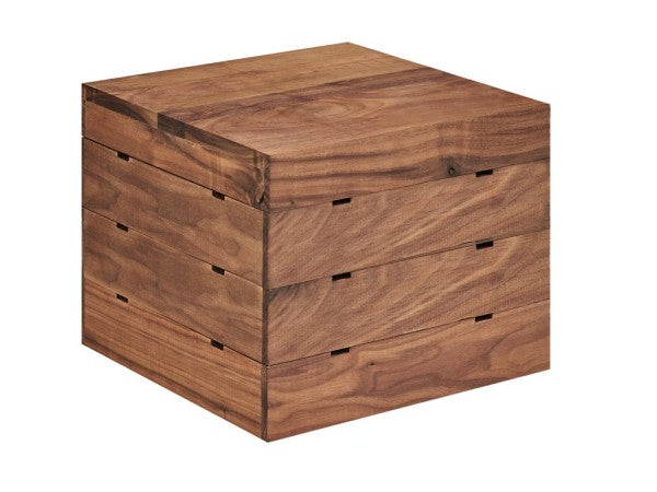 A square, walnut wooden box with a smooth finish and visible grain. Three horizontal segments hint at drawers or nesting layers. The plain white background highlights the rich color and Mid-Century Crate Riser-inspired modern design.