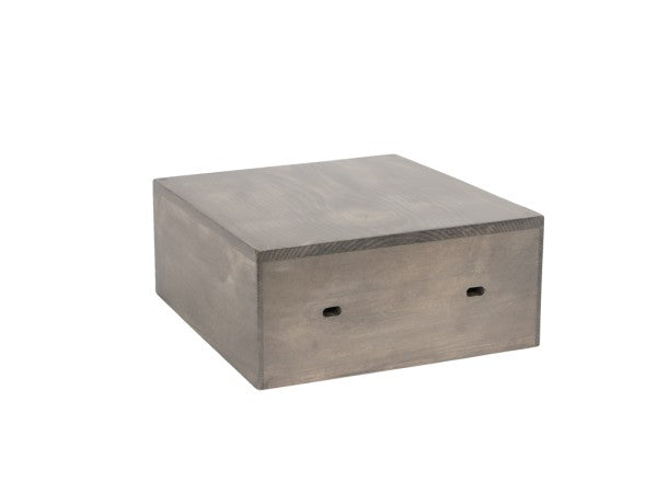 A rectangular wooden box with a smooth, grayish finish, the Cal-Mil 3628-4-110 Aspen Crate Riser features two small horizontal slots on the front panel. It sits on a flat white background, boasting shelf support brackets and a sturdy, modern minimalist design.