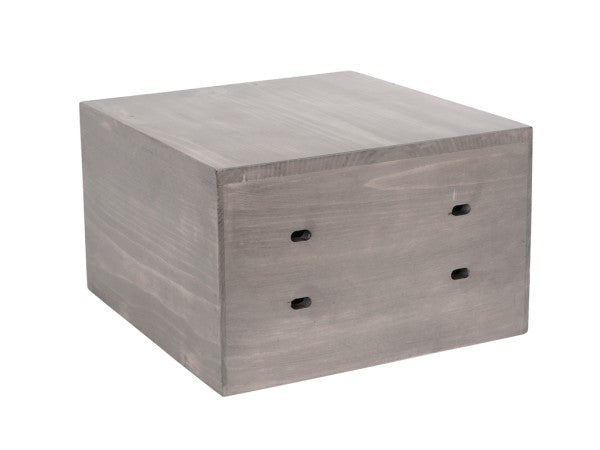 A square, industrial-style gray wooden box with visible wood grain texture, the Aspen Crate Riser features two pairs of vertical slits on the front panel and a matte finish. Its slightly rounded corners add to the appeal of this Cal-Mil 3628-7-110 shelf support.