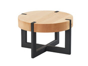A round maple display riser with a thick light wood top and a modern black metal base featuring four intersecting legs that form an X-shape, supporting the tabletop.