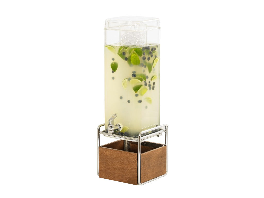 A 3 gallon beverage dispenser filled with light yellow liquid, lime slices, and blueberries sits on a metal stand with a wooden base. The dispenser has a spigot at the front and is topped with a clear plastic lid containing ice cubes.