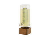 A tall, clear Mid-Century Beverage Dispenser with 3 gallon capacity, filled with light yellow liquid and floating fruit slices, sits on a metal stand with a wooden base. It features an infusion chamber, spigot, and transparent lid on top.