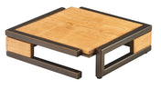 A modern, square coffee table with a light wood top and matching side panels, supported by a dark metal frame in a bronze finish. Open sides and mixed materials give it a minimalist, contemporary look. The table sits low to the ground.