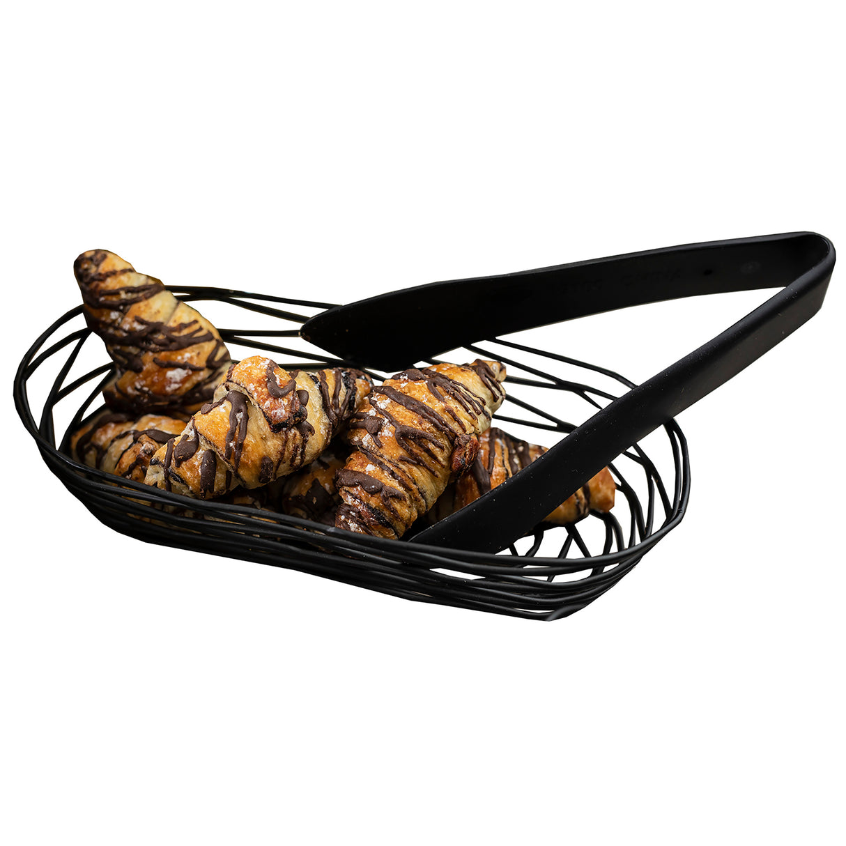 A black wire basket holds several small croissants drizzled with chocolate, accompanied by heat safe black tongs resting on the basket. The image is set against a white background.