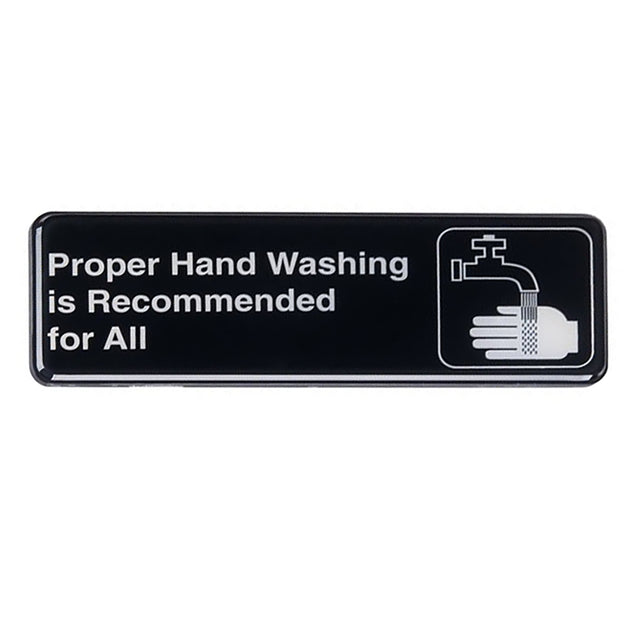 A rectangular black hand washing sign with white text reads Proper Hand Washing is Recommended for All. To the right, a white icon shows a faucet with water flowing onto a hand. Features adhesive backing for easy installation.