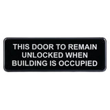 A black rectangular Door Unlocked Sign with white, bold, capital letters reads: “THIS DOOR TO REMAIN UNLOCKED WHEN BUILDING IS OCCUPIED.” Features adhesive backing for easy installation.