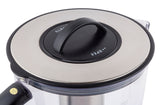 Close-up of a pitcher lid with a black handle and metallic silver top. The lid, made of stainless steel, features “OPEN” and “CLOSE” markers with arrows and is attached to a clear container with a black handle partially visible on the left.