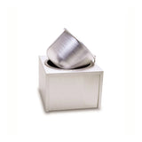 A metallic, brushed-steel insert pot is tilted and partially inserted into a square, white, modern counter-top unit with an opening on top, set against a plain white background. The minimalist design gives a contemporary and sleek appearance.