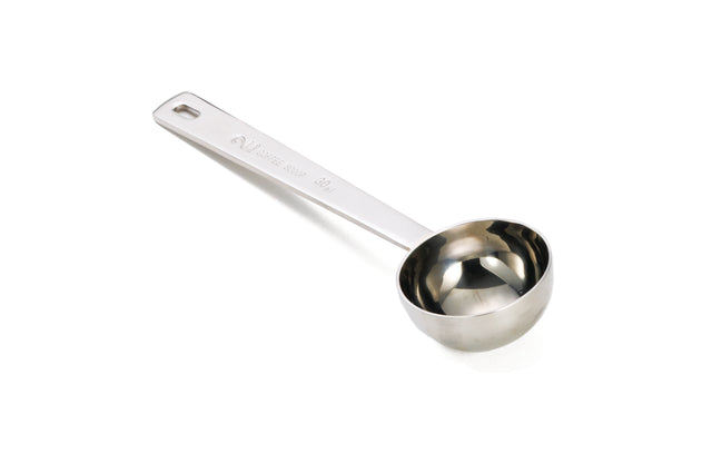A stainless steel Coffee Scoop with a long handle and a round deep cup, placed on a white background. The handle features engraved 2 tablespoon measurement markings and a small hole at the end for hanging.