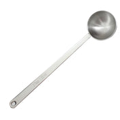 This long handled measuring spoon is crafted from durable stainless steel, featuring a round, deep bowl. The handle displays an engraving of 2 Tbsp / 30 ml and includes a small hole at the end for convenient hanging.