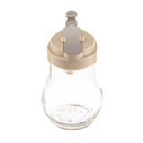 A clear teardrop glass dispenser with a beige plastic lid and gray metal lever mechanism sits on a white background. The jar is empty, clean, dishwasher safe, and features no visible labels or markings on its sides.