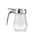 A clear teardrop glass syrup dispenser with a curved body and a shiny silver metal lid and lever handle, isolated on a white background. The dispenser is empty, the lever is raised slightly, and it is dishwasher safe.