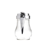 A clear, teardrop glass syrup dispenser with a silver metal lid and a long, curved lever for pouring. The dispenser is photographed against a plain white background, centered in the image, and is dishwasher safe for easy cleaning.