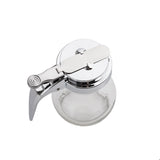 A clear teardrop glass dispenser with a silver metal lid and handle, viewed from above. The lid features a lever for easy pouring. This dishwasher safe container is empty and set against a plain white background.