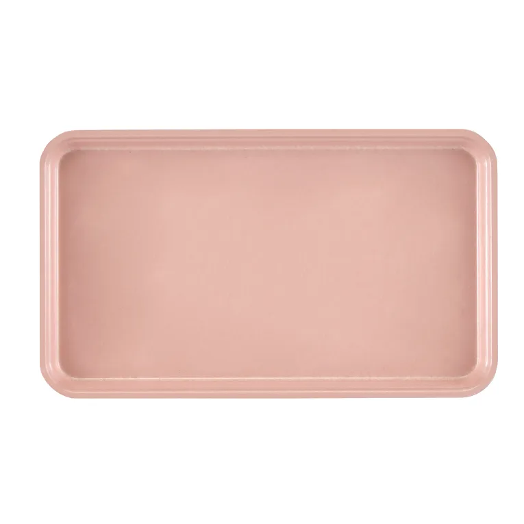A rectangular Camtray with rounded corners is shown from above. Made of high-impact fiberglass, the solid light pink tray features a slightly raised rim and sits on a white background. Its smooth surface is unadorned and dishwasher safe.