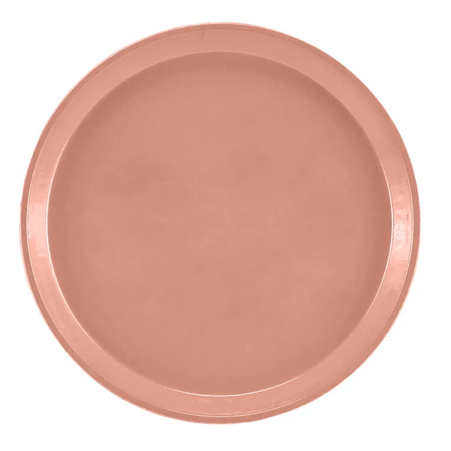 A plain, round plate in a muted pink or terracotta color, viewed from above. The plate has a smooth surface and slightly raised rim, reminiscent of a Serving Camtray. It is dishwasher safe and rests on a white background.