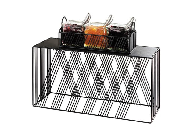 A black metal wire condiment holder with a geometric design holds three glass jars filled with red, orange, and dark purple jams, each BPA Free and with a clear spoon. The jars are arranged in a tray on top of the rack against a white background.