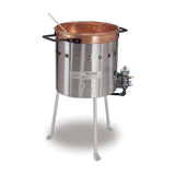 A large metal kettle with a copper pot inside sits on three legs, perfect for outdoor use. Two handles grace the pot, with a wooden stir stick resting inside. The kettle has circular vents and an LP gas burner control on the side. Background is plain white.
