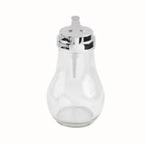 A clear glass TableCraft 414 syrup dispenser with a shiny metal lid, lever-style spout, and secure dispenser gasket. Teardrop-shaped with a wide base and narrow neck, this empty dispenser is dishwasher safe and shown against a white background.