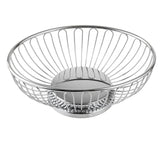 A round, chrome plated metal wire Chalet Basket with an open, airy design. The vertical rods connect the rim to a solid base, giving this TableCraft piece a modern and minimalist appearance. The background is plain white.