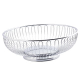 A round, chrome plated Chalet Basket by TableCraft with an open, minimalist design. Vertical metal bars form the sides and a solid circular base. The modern basket is empty and displayed on a white background.