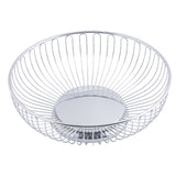 A round, chrome plated Chalet Basket by TableCraft, featuring an open design with evenly spaced vertical wires that curve outward from a solid circular base, creating a simple and modern appearance. The inside is empty.