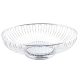 A round, shallow, chrome plated Chalet Basket by TableCraft Products with an open, airy design. Evenly spaced vertical wires curve outward from a solid base, giving this modern fruit basket a minimalist look. The basket is empty.