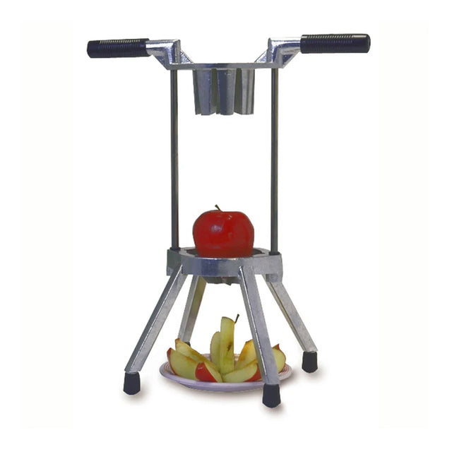 A metal Apple Hacker apple slicer with handles and four legs stands on a surface. A whole red apple is positioned under the blades, while sliced pieces are arranged on a plate beneath it. The background is plain white.