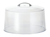 A clear, round plastic cake cover with a flat base and curved lid. The lid features a small, built-in handle for effortless lifting. This transparent dome is dishwasher safe and displayed empty against a white background.