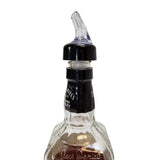 A clear liquor bottle with Jack Daniels embossed on the neck is shown against a white background. The bottle features a Proper Pour 1-1/4 oz pourer by TableCraft Products for precise and controlled serving.