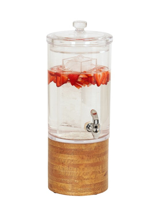 A clear polycarbonate beverage dispenser with a spigot sits on a wood base. Filled with water, ice cubes, and sliced strawberries floating inside, the dispenser is topped with a lid against a white background.