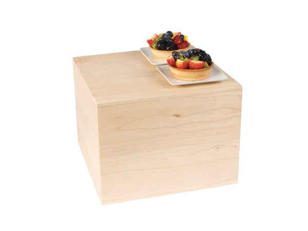 A Cal-Mil Blonde Square Riser serves as the elegant base for two square white plates, each displaying a fruit tart filled with colorful assorted berries and sliced fruit, all set against a plain white background.