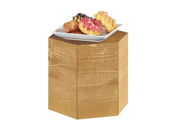 A small rustic pine Madera Riser pedestal with a white square plate on top, holding four assorted pastries: a pink-frosted donut, a twisted pastry, a chocolate-drizzled pastry, and a glazed pastry.