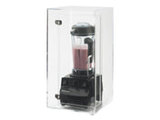 A black Vitamix blender with pink liquid inside sits in a Cal-Mil Blender Sound-Reduction Housing, a universal fit enclosure with metal hinges and a hinged door, photographed against a white background. It helps reduce noise during blending.