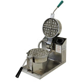 A Belgian Waffle Baker with stainless steel construction, black handles, and a green-tipped lever. The lid is raised, showing cast aluminum grids in the round mold. Control dials and warning labels are visible on the base.