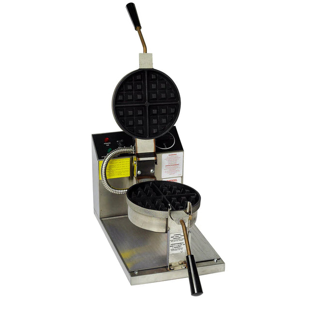 A commercial Belgian Waffle Baker with a round, open cooking plate featuring a baked waffle inside. The stainless steel machine has black handles, thermostat heat control, a non-stick coating, and a yellow instruction label on its front.