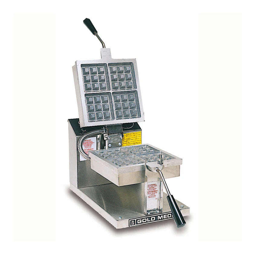 A stainless steel Belgian Waffle Baker with a raised handle, cast aluminum grids, and control knobs on the side. The Gold Medal machine is designed to bake four square waffles at once using two hinged waffle plates.