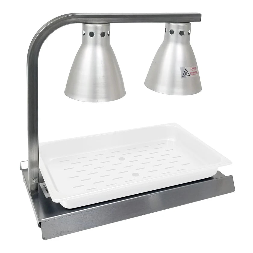 The Warma-Serve Food Warmer features two cone-shaped heat lamps above a rectangular white tray on a metal base, designed to keep food warm in commercial or buffet settings. The stainless steel food warmer includes ventilation holes and a caution sticker.