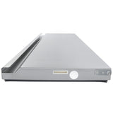 A flat, rectangular stainless steel appliance with a raised back edge, control knobs, and a display area—similar to equipment found in Empura Refrigeration setups—likely a commercial kitchen griddle or grill shown from the front at a low angle.
